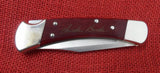 Buck 0110CWSNK 110 Folding Hunter Knife Chairman Series Chuck Buck Signature Cherrywood Dymondwood USA Lot#110-223