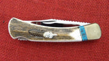 Buck 0110EKSLE1 110 Folding Hunter Knife 2009 WBC Elk Stag Turkey Feather Inlay NIB LOT#110-241
