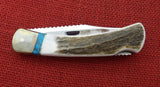 Buck 0110EKSLE1 110 Folding Hunter Knife 2009 WBC Elk Stag Turkey Feather Inlay NIB LOT#110-241